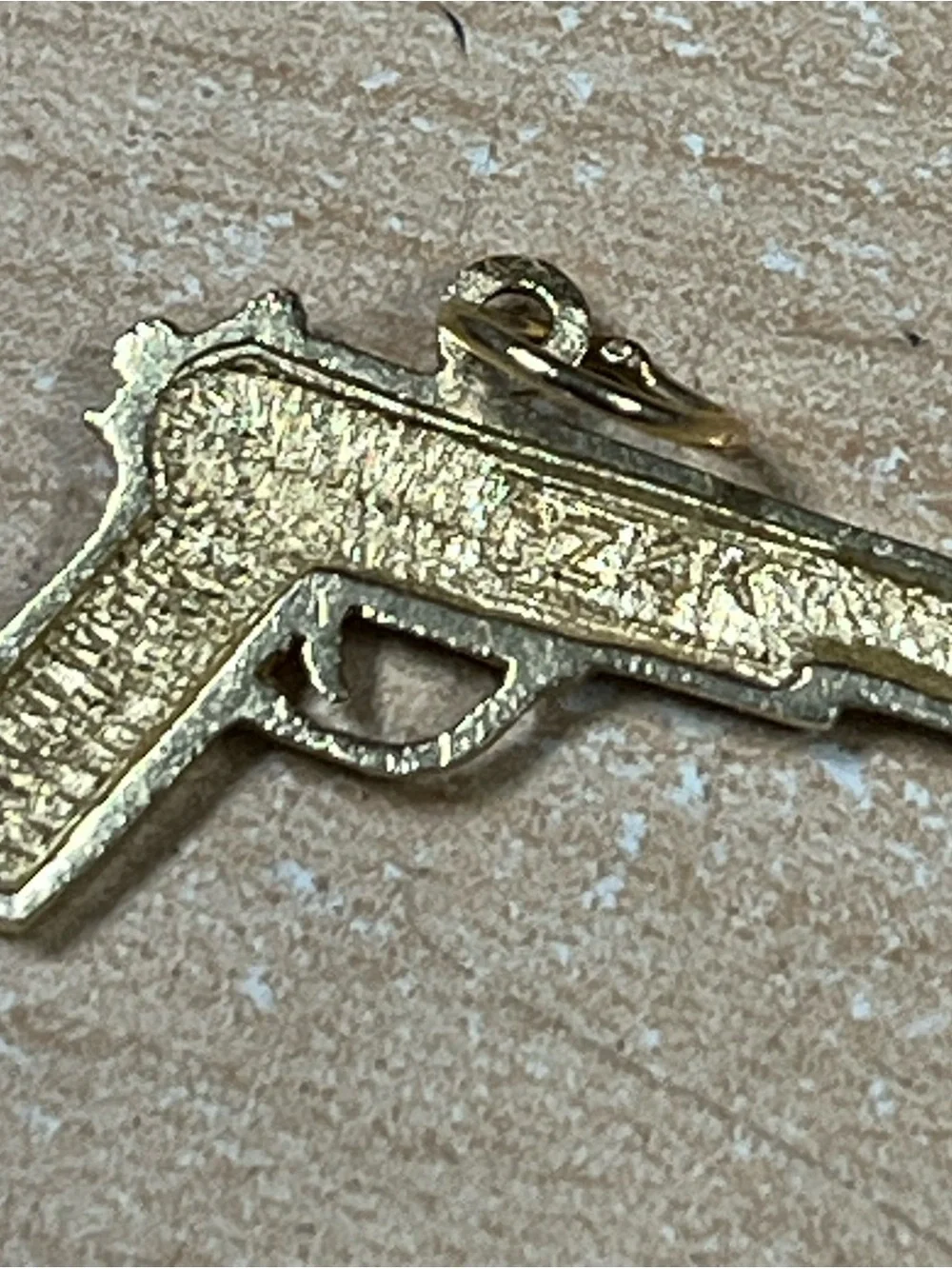 14K rendition of a tactical handgun. 2.8 grams of pure 14K gold.